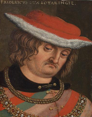 Bust-length oil portrait identified as Ferry IV, Duke of Lorraine: a heavy-featured, moustached sitter in a broad red cap with a white fur brim, wearing a slashed doublet of red and green beneath two gold chains and a jewelled collar, the panel inscribed FRIDERICVS DVX LOTARINGIE across the top, against a dark ground